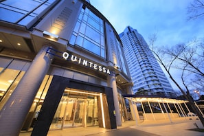 A modern building with a 'QUINTESSA' sign, large windows, and a covered entrance area. - Quintessa Hotel Osaka Bay (Osaka)