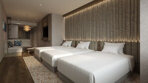 A modern hotel room with a large bed, a seating area, and a decorative wall panel. - Quintessa Hotel Osaka Bay (Osaka)