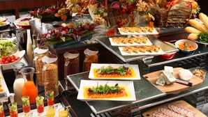 A buffet with various dishes, including salmon, cheese, and bread. - Quintessa Hotel Osaka Bay (Osaka)