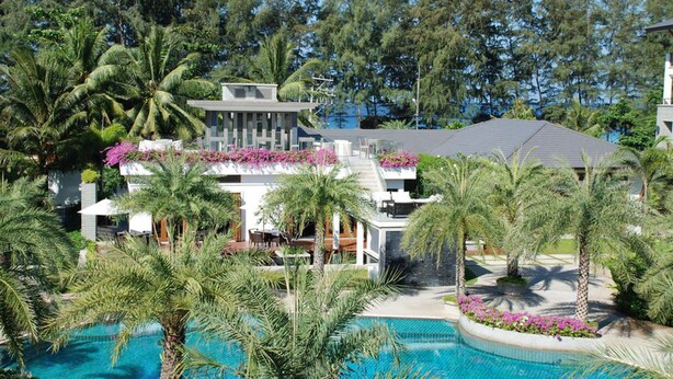 A resort with a swimming pool, palm trees, and a building with a flat roof. - The Pearl of Naithon (Sa Khu)