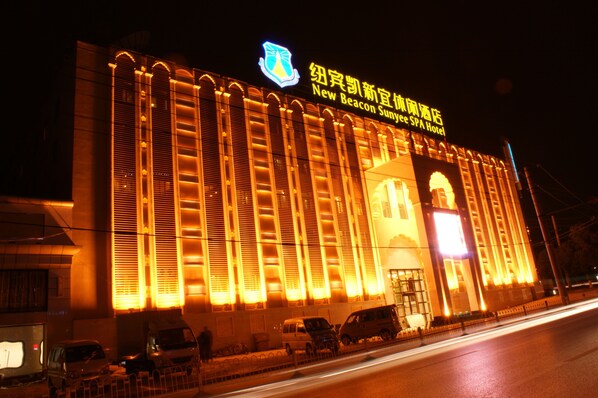 A large building with a prominent sign reading "New Beacon Sunny Spa Hotel."