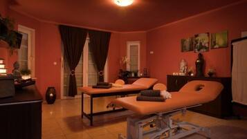 Relax in this serene space, featuring a massage table and treatment bed, perfect for rejuvenation.