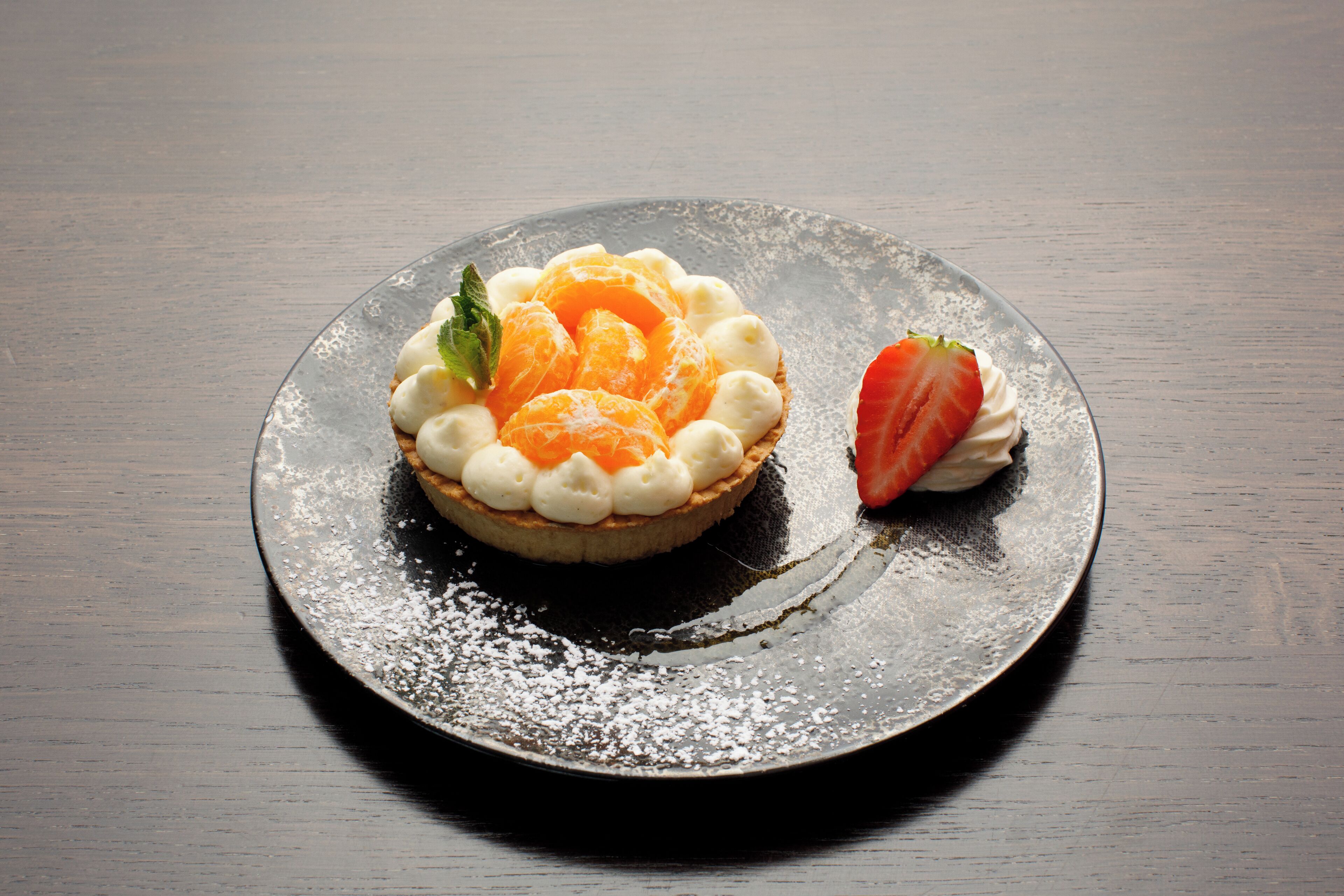 A dessert on a plate with powdered sugar.