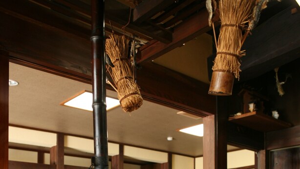 A traditional Japanese room with tatami flooring, wooden furniture, and a hanging fish decoration. - Sosuke (Takayama)