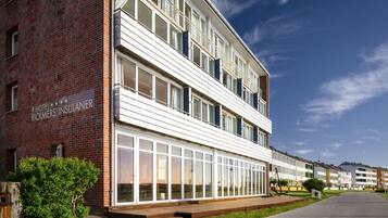 A multi-story hotel with a brick facade and large windows.