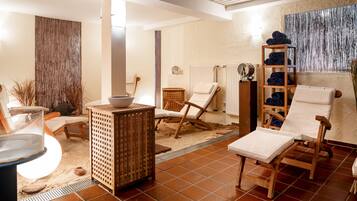 Relax in a serene spa area with seating options, a refreshment table, and a calming ambiance.