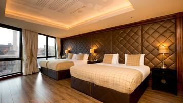 A hotel room with two beds, a city view, and a modern design.
