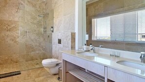 A modern bathroom with a large mirror, two sinks, and a shower area. - Vetho Villa (Cape Town)