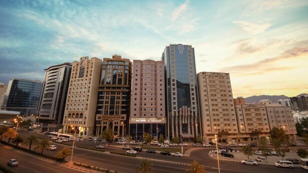 A multi-story hotel with a modern design, featuring a central atrium and multiple entry points. - Snood Al Aziziah (Makkah)