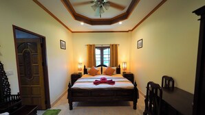 A bedroom with a bed, bedside tables, a desk, and a chair. - Stella Resort (Sam Roi Yot)