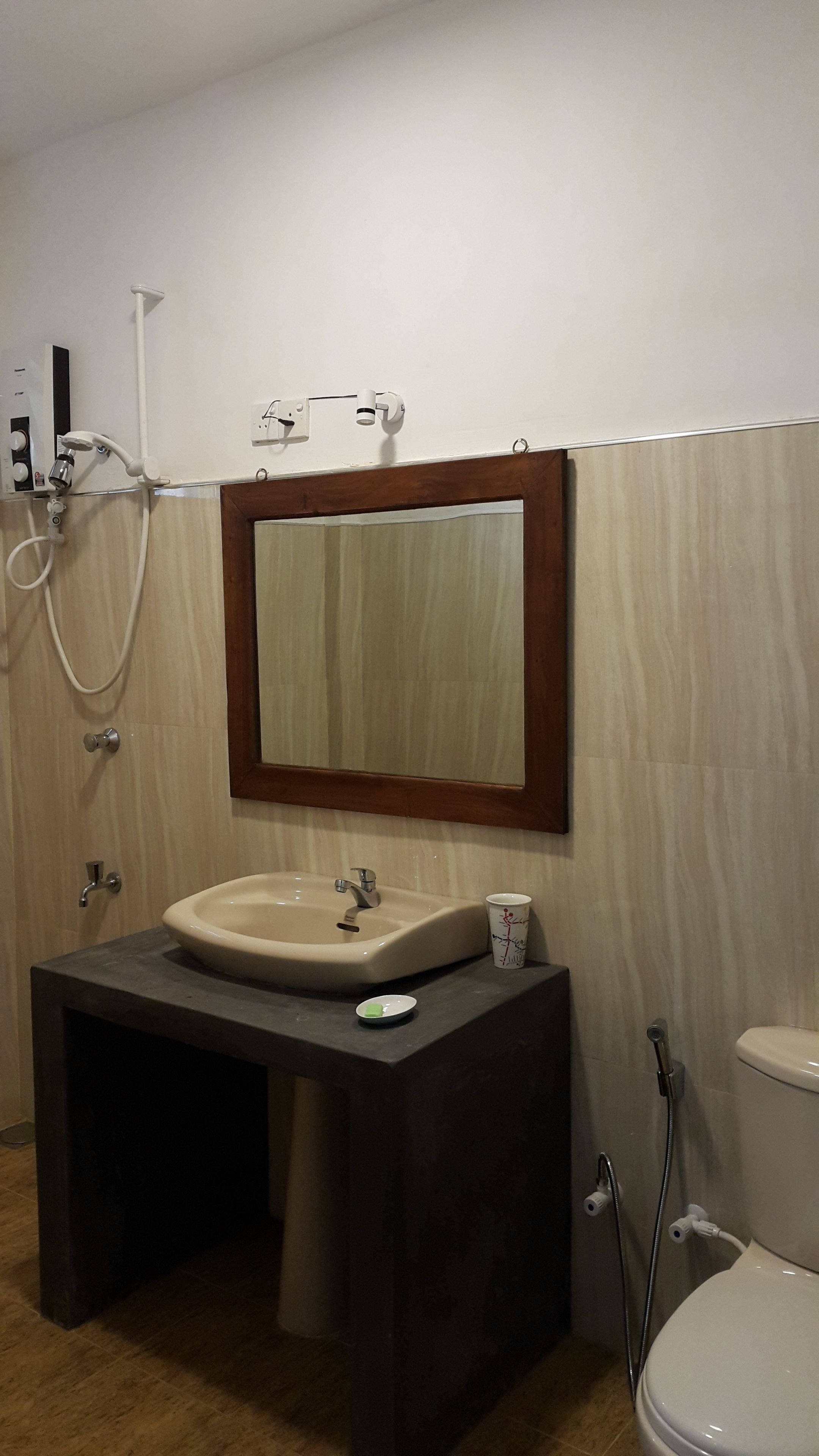 A bathroom with a sink, mirror, and toilet.