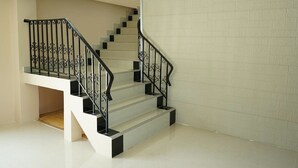 A staircase with black railings and white steps, leading to an upper floor. - Sea Land View (Si Racha)