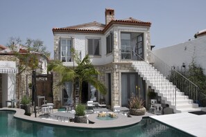 A luxurious house with a swimming pool, outdoor seating, and a staircase leading to the upper floor. - Ala Hotel - Special Class - Adults Only (Cesme)