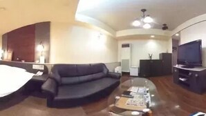 A modern hotel room with a bed, a sofa, a glass coffee table, and a TV. - Hotel Joy -Adult Only (Komaki)