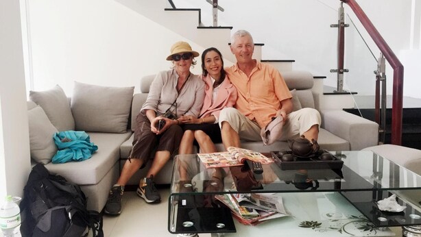 A living room with a sofa, a glass coffee table, and a staircase in the background. - The Times Hotel (Hue)