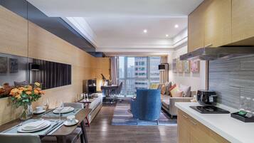 A modern kitchen with a dining area, large windows, and a view of the city.