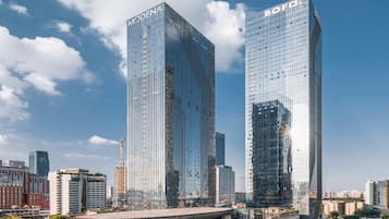 Two high-rise buildings with reflective glass facades, one labeled 'MODENA' and the other 'BOF'.