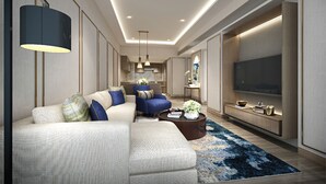 Una sala de estar moderna con un sofá modular, una mesa de centro y un televisor de pantalla plana.