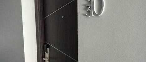 A modern door with a digital number display showing "30".