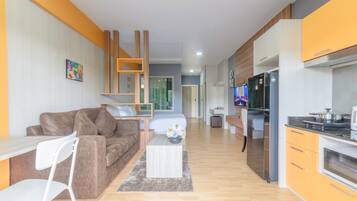 A modern apartment with a living room, kitchen, and bedroom.