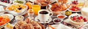 A breakfast buffet with various food items and beverages.