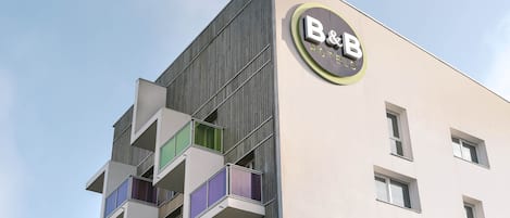 Un moderno edificio de hotel con un letrero destacado que dice "B&B HOTEL".