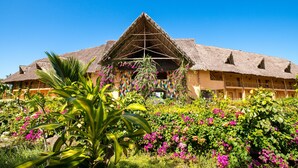 A large building with a thatched roof and multiple windows. - Zanzibar Queen Hotel (Matemwe)