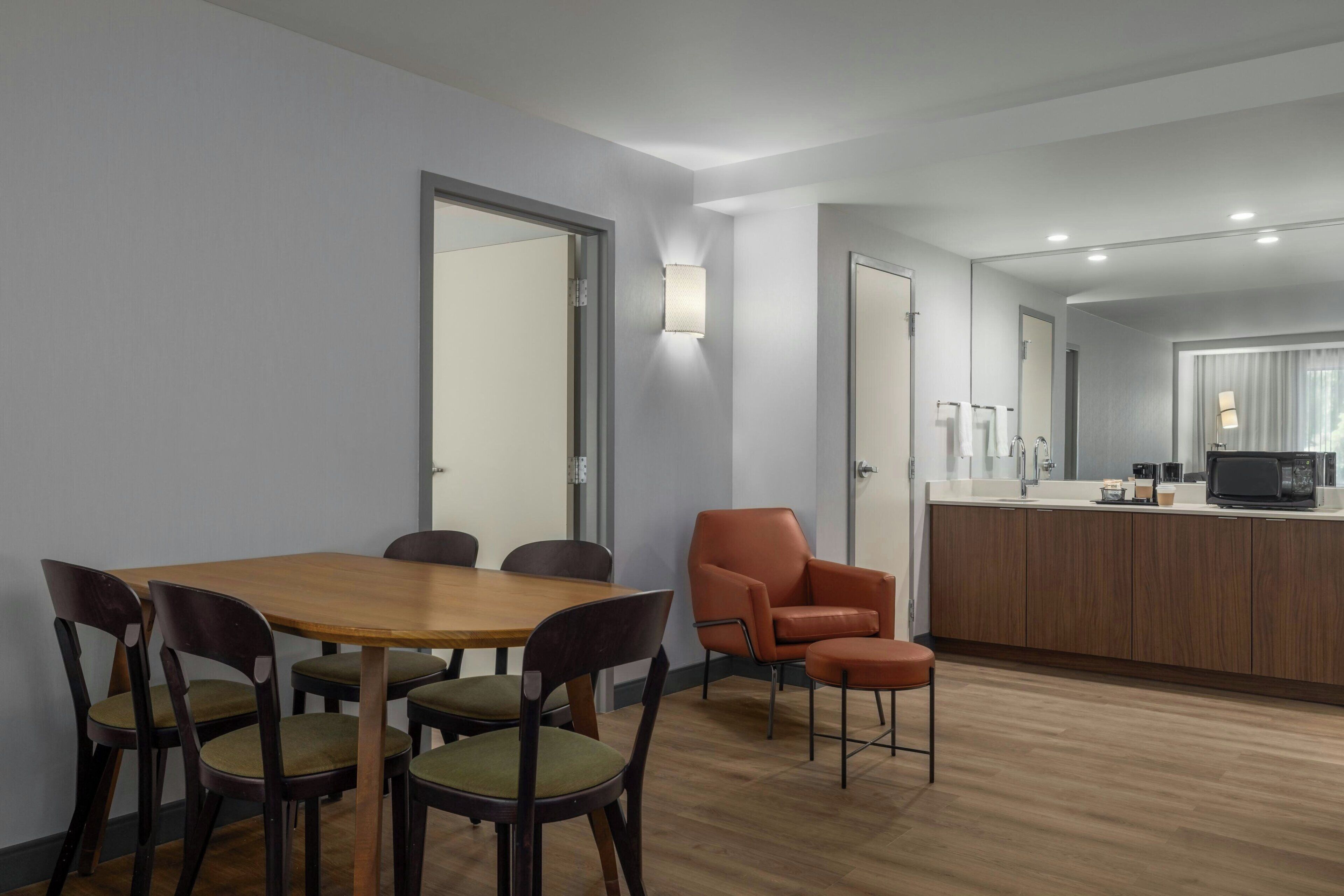 A modern kitchen with a wooden countertop, a microwave, and a sink.