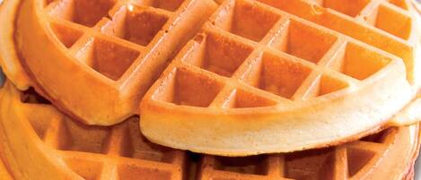 A close-up of a waffle with a golden-brown color and a grid pattern.
