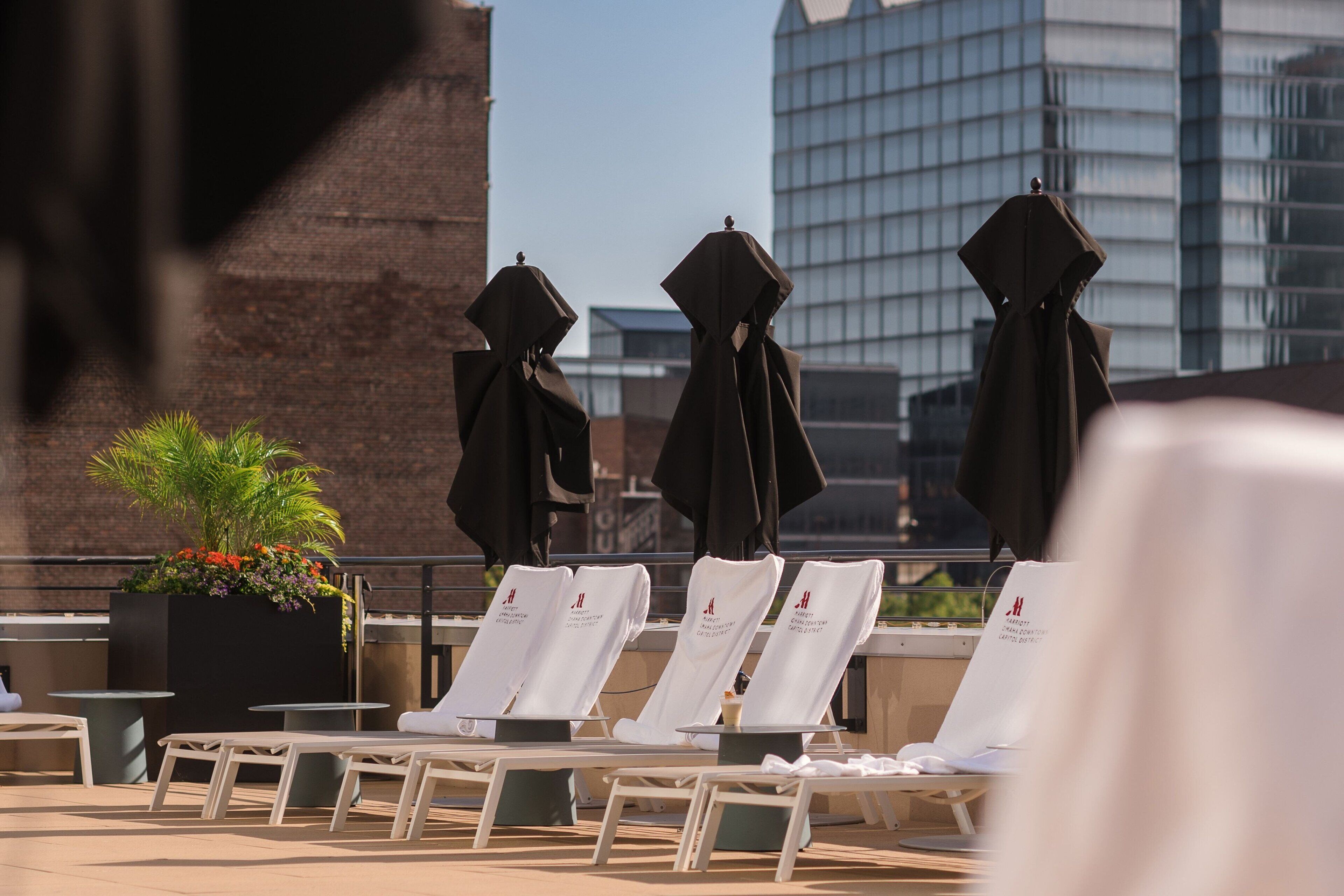 Seasonal outdoor pool, open 10:00 AM to 8:00 PM, pool umbrellas