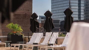 Seasonal outdoor pool, open 10:00 AM to 8:00 PM, pool umbrellas