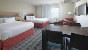 A hotel room with two beds, a dining table, and a TV. - TownePlace Suites by Marriott Denver South/Lone Tree (Lone Tree)