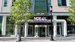 A hotel entrance with a glass door, a sign reading 'yotel', and a number '65' above the door. - YOTEL Boston, Select by Hilton (Boston)