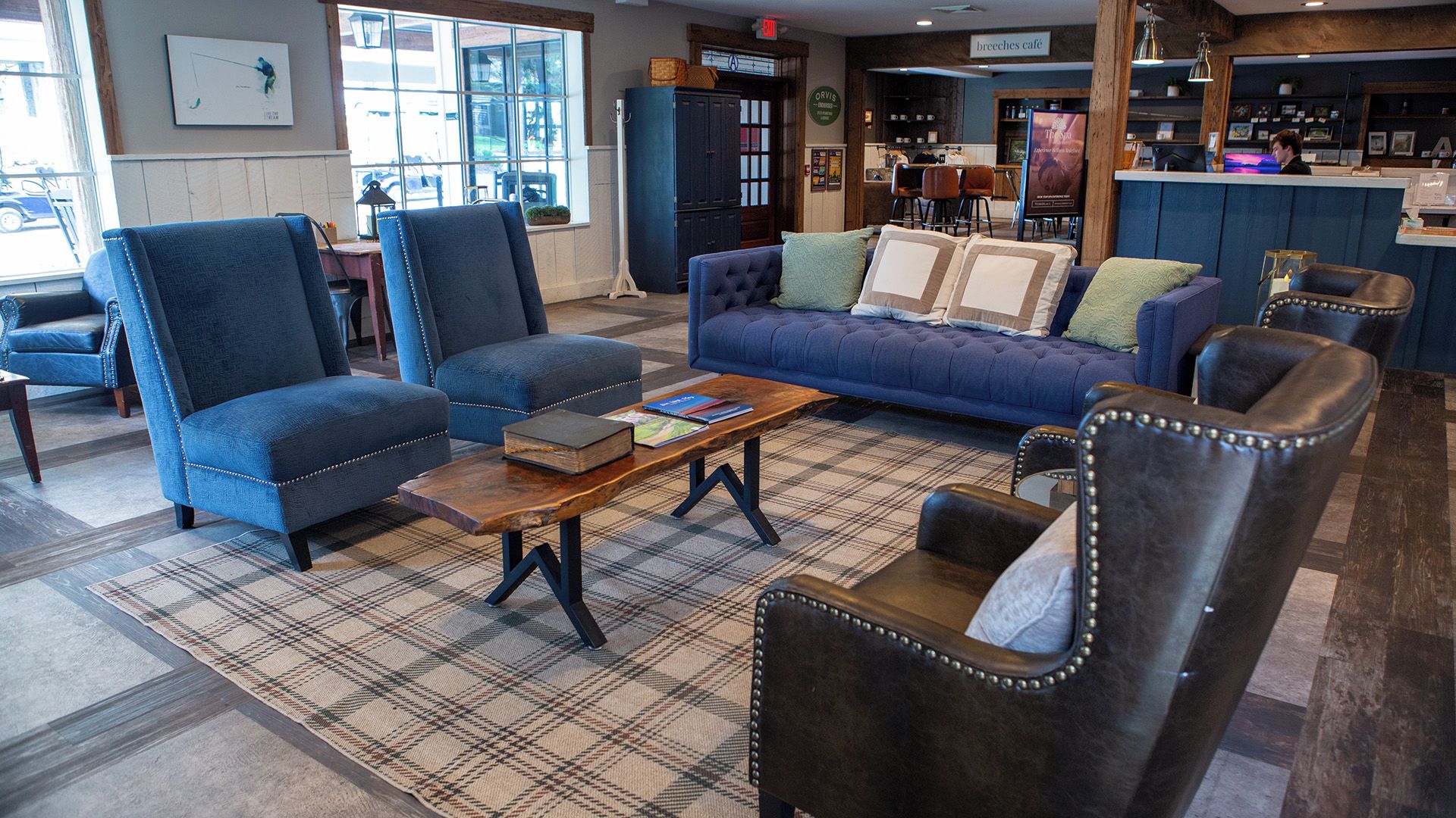 A cozy lounge area with a sofa, armchairs, and a coffee table.