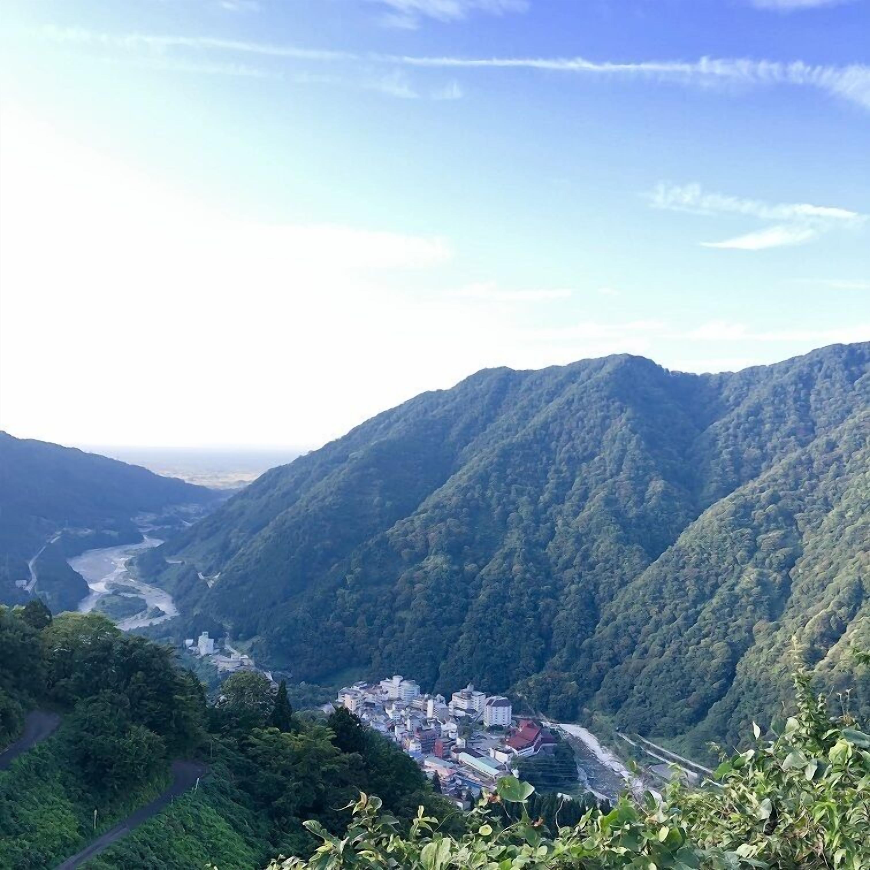 A mountainous landscape with a town nestled in a valley.