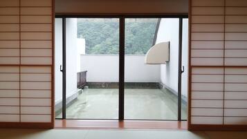 A room with a sliding glass door leading to a balcony.