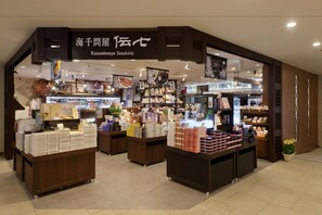 A store interior with multiple display counters and shelves stocked with various products. - Kurobe Unazuki Onsen Yamanoha（ORIX HOTELS & RESORTS） (Kurobe)