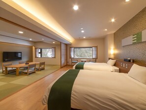 A hotel room with two beds, a TV, a desk with chairs, and a large window. - Kurobe Unazuki Onsen Yamanoha（ORIX HOTELS & RESORTS） (Kurobe)