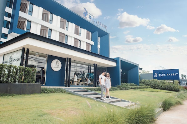 A hotel with a modern design, featuring a prominent sign for the Blue Rabbit Hotel.