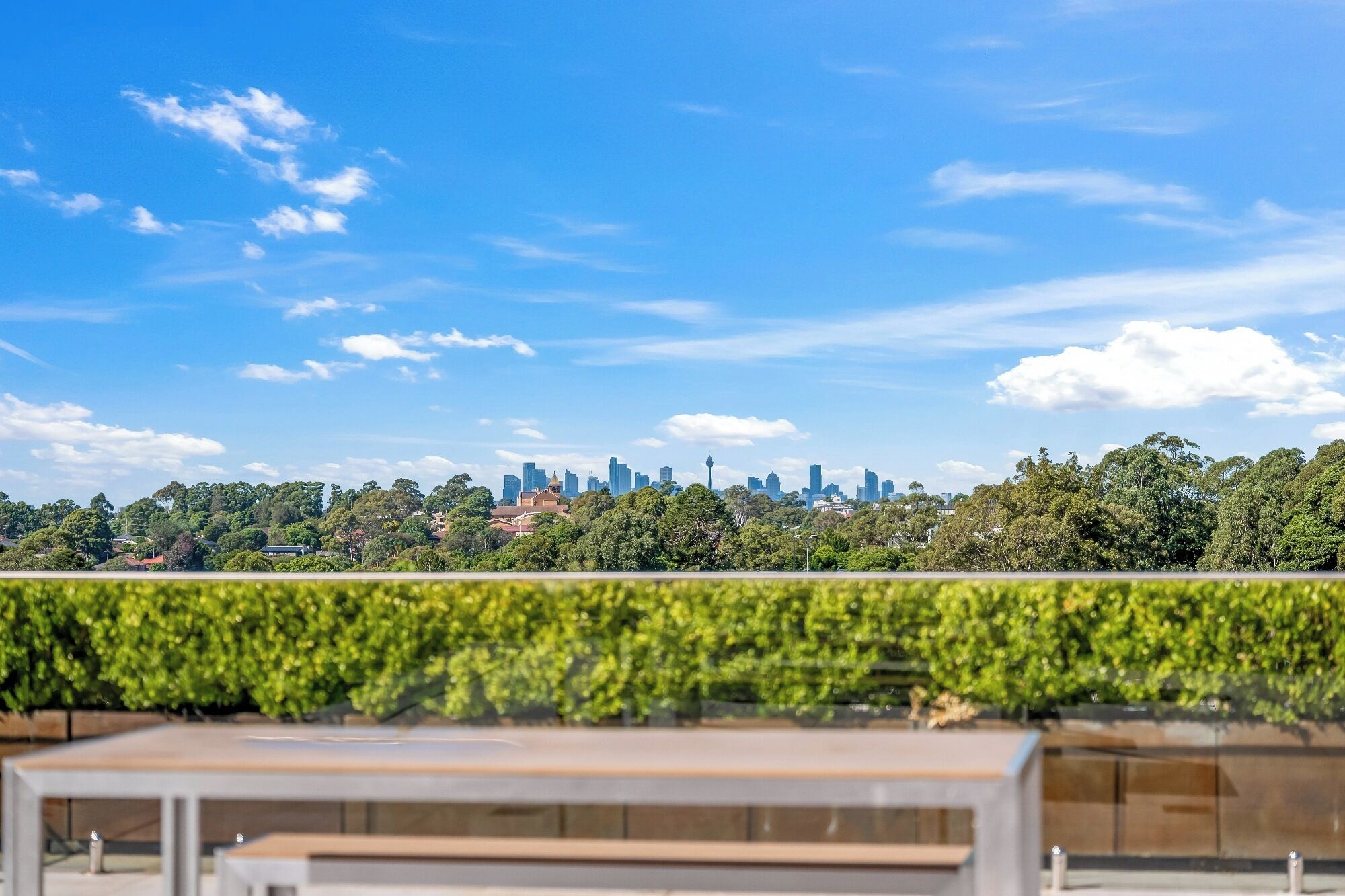 A city skyline with modern buildings and a clear blue sky.