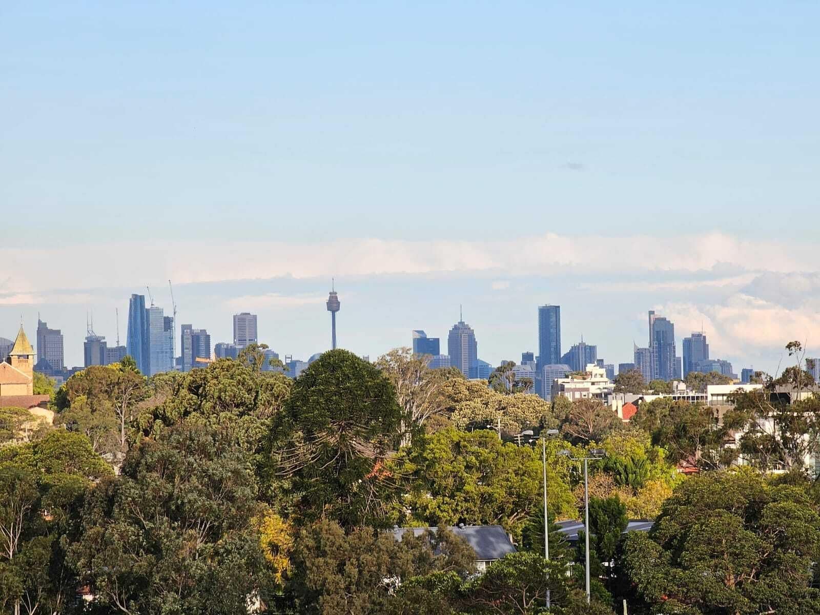 A city skyline with modern buildings and a prominent tower.