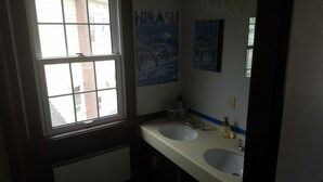 A bathroom with two sinks, a window, and a mirror. - Australia House (Kutchan)