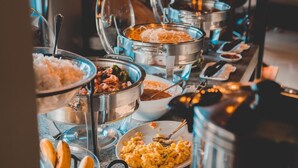 A buffet setup with various food items and utensils. - Amaris Bed & Breakfast (Lapu-Lapu)