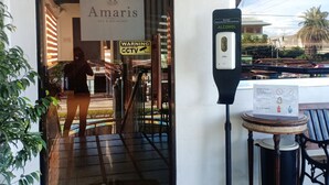 Entrada de un hotel con un letrero que dice 'Amaris Bed & Breakfast' y un aviso de videovigilancia.