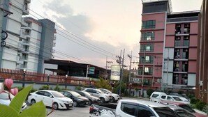 Un estacionamiento con varios autos, incluyendo un SUV blanco con la marca 'TRITON'.
