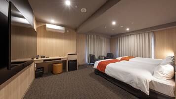 A hotel room with a bed, desk, and TV.