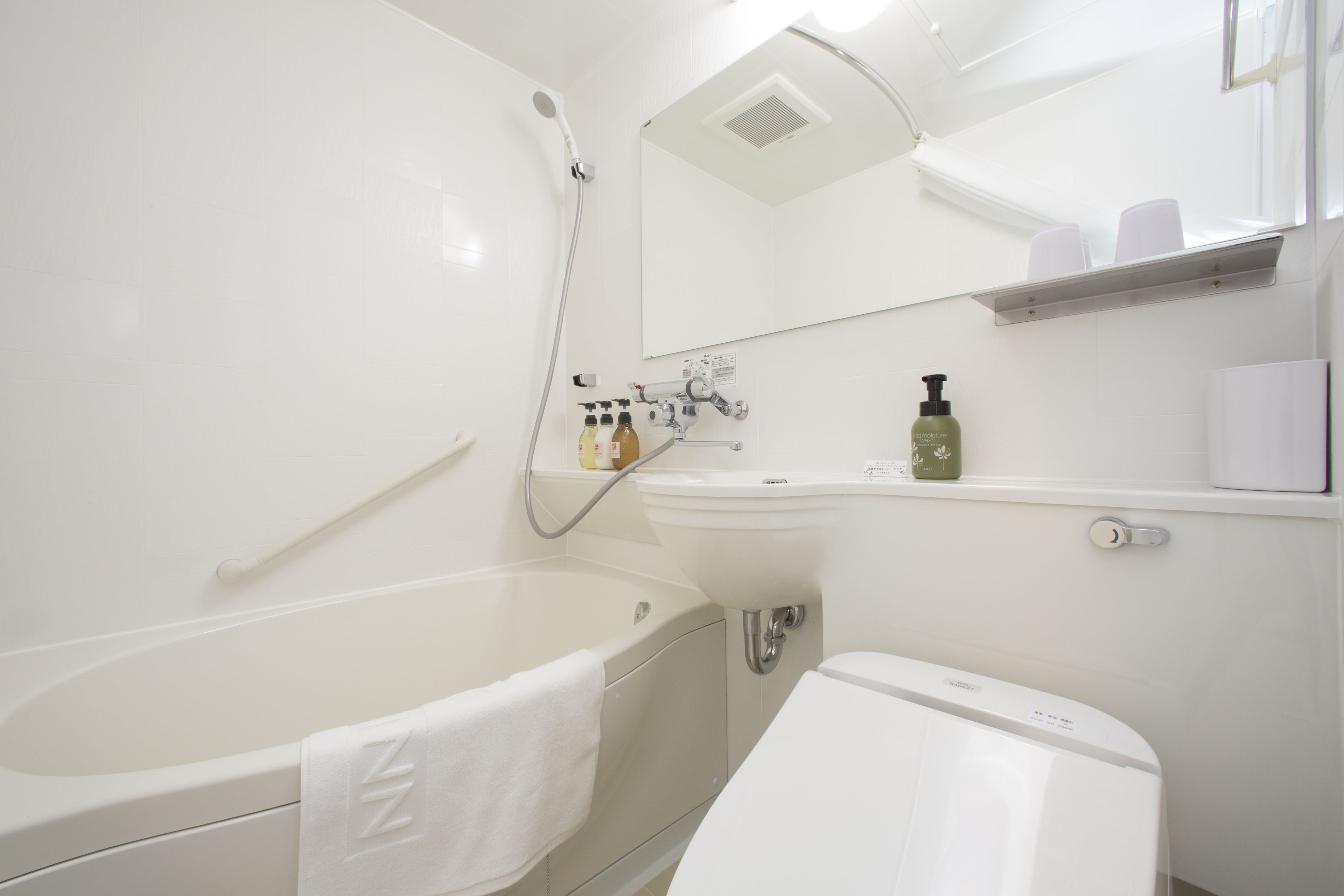 A modern bathroom with a bathtub, a sink, and a toilet.