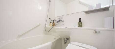 A modern bathroom with a bathtub, a sink, and a toilet.