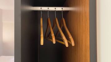 A closet with wooden hangers and a metal rod.