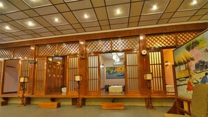 A traditional Japanese-style room with tatami flooring, shoji screens, and a painting on the wall. - Arirang Hotel (Kampala)
